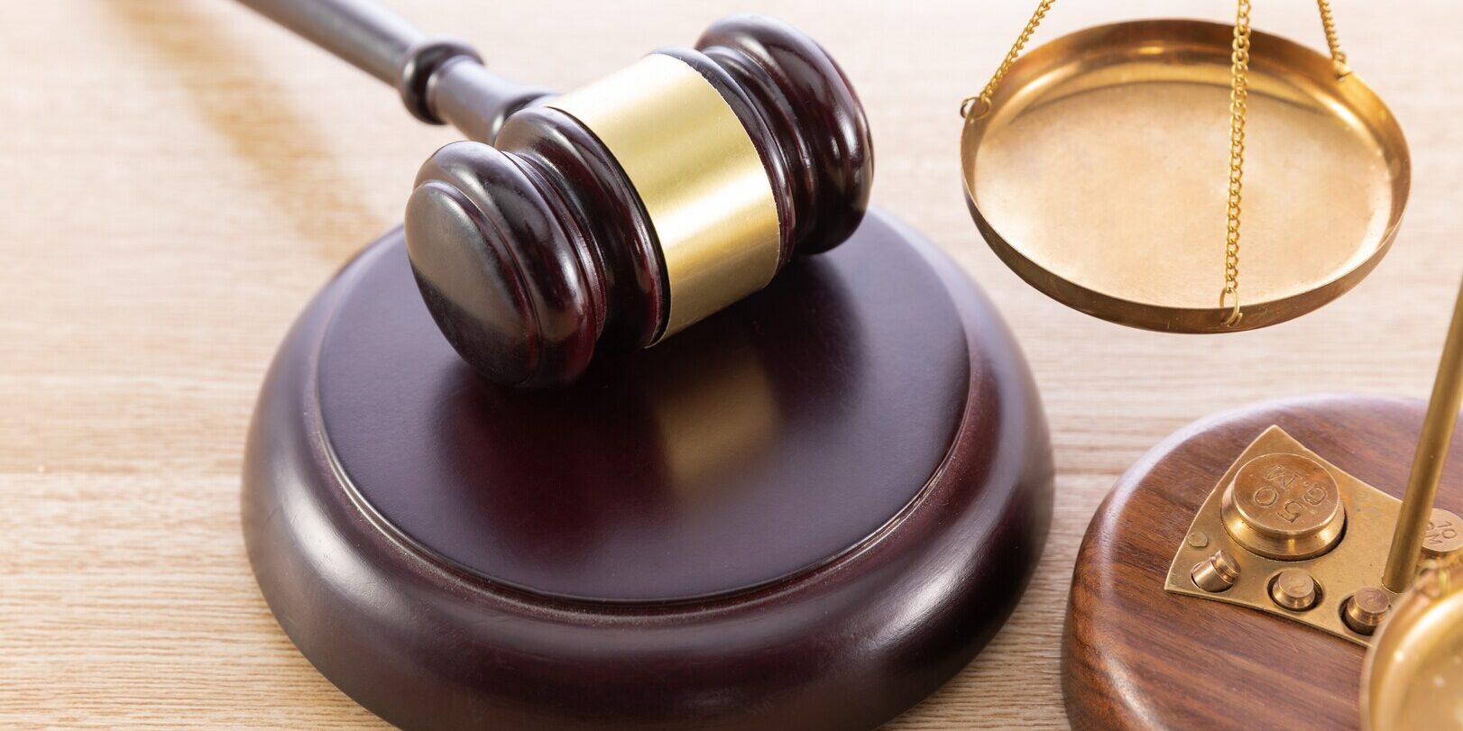 High angle shot of a gavel and a scale on a wooden surface